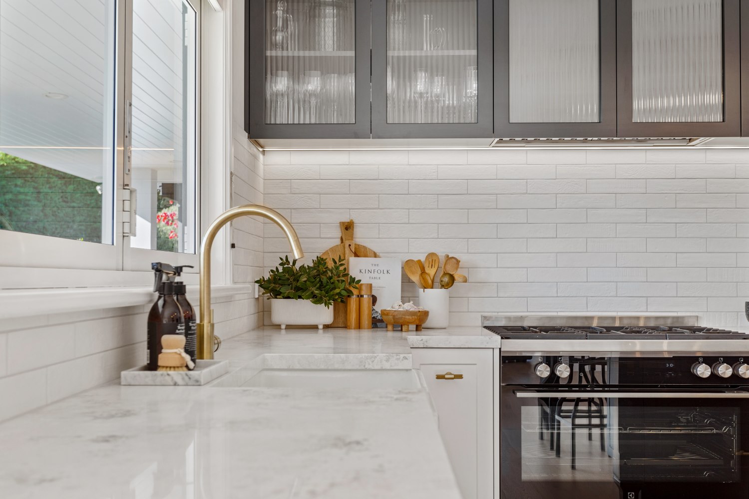 Modern kitchen countertop. Featuring oven, cabinets and kitchen decor.